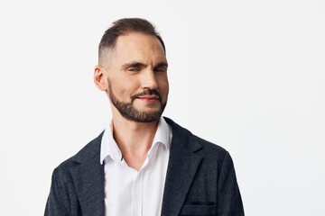 A business professional man stands against a clean white background, radiating confidence and...