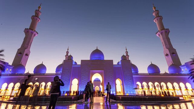 Wide-angle timelapse of Sheikh Zayed Grand Mosque at sunset with glowing domes and dramatic sky