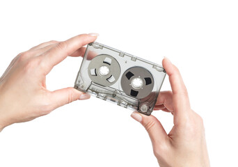 Female hands holding a clear cassette tape with magnetic reels, isolated on transparent background, retro analog audio concept, nostalgic media, minimalist composition.