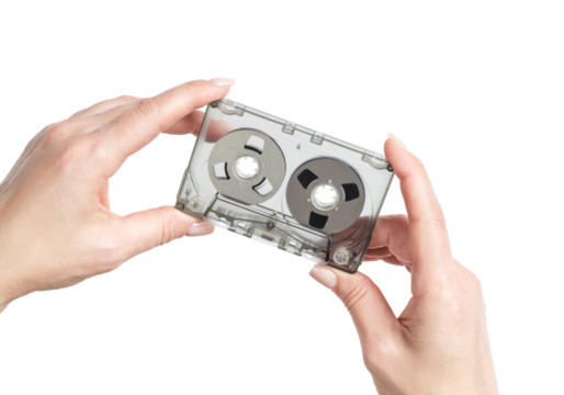 Female hands holding a clear cassette tape with magnetic reels, isolated on transparent background, retro analog audio concept, nostalgic media, minimalist composition.