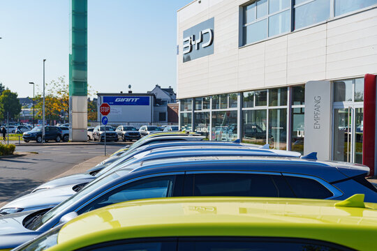 Dusseldorf, Germany - September 28 2025: Newly opened Chinese automaker company BYD dealership with cars for sale parked in front of it