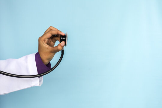 A doctor hands is holding a stethoscope on an isolated background