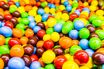 Chocolate dragees in vibrant colored glaze