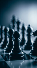 A dark pawn stands prominently on a chess board, ready for strategic battle.
