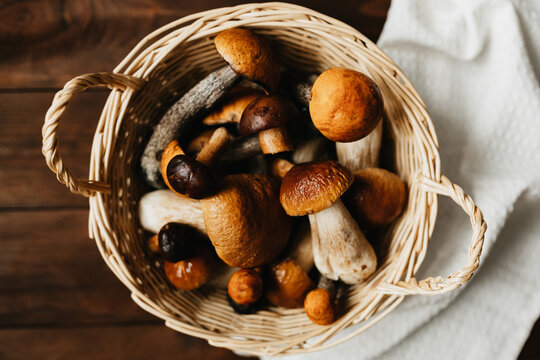 Basket of boletus mushrooms on wooden table