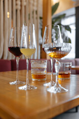 Cocktail of whiskey, scotch, brandy, wine and lemonade in glass glasses on a restaurant table. Bar set of cocktails for a party