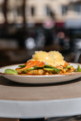 Toast with eggs benedict red fish and spinach. Breakfast lunch and dinner in a restaurant