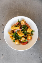 Warm vegan salad with vegetables and pear. Salad without meat