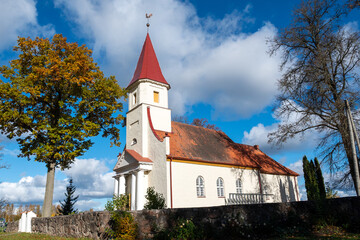 landscape with a white country church, trees around in autumn colors, wonderful nature in autumn,...
