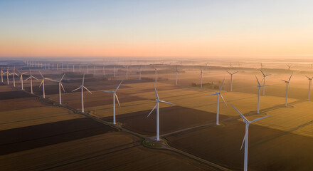 Aerial Drone View of Wind Turbine Field at Sunrise