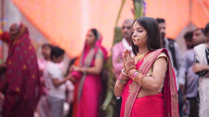 Women doing namaskar to rising Sun God during Chhath Puja festival.