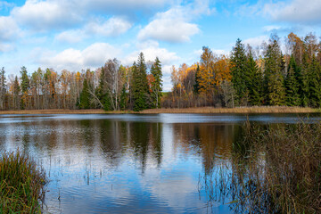 autumn landscape, lake shore, day by the lake, colorful trees reflecting in the lake water, Vaidava...