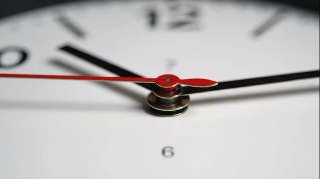 An extreme macro shot captures the smooth, relentless sweep of a minimalist wall clock's second hand across the numbers.