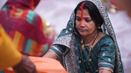 Woman standing in water giving Arghya to Chhathi Maiya at sunrise, part of the sacred Chhath Puja ritual symbolizing devotion and purity.