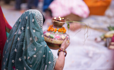 Woman giving Arghya to Chhathi Maiya during Chhath Puja sunrise ritual, offering prayers with faith, devotion, and spiritual purity.