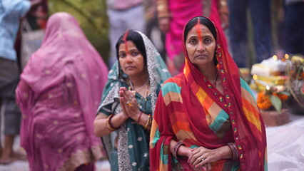 Devotee womens in sacred water praying to the Sun God during Chhath Puja, symbolizing faith, purity, and spiritual devotion.