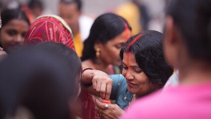 Woman performing sindoor ritual after finishing morning prayer during Chhath Puja, showing devotion and spiritual strength.