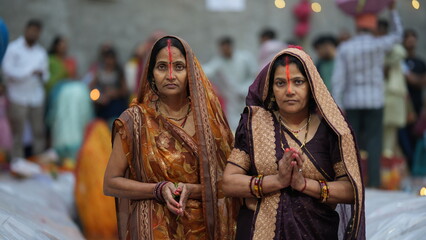 Womans during Chhath Puja morning prayer, symbolizing devotion, faith, and cultural beauty.