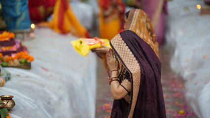 Close-up portrait of woman holding offerings during Chhath Puja celebration, reflecting faith and spiritual beauty.
