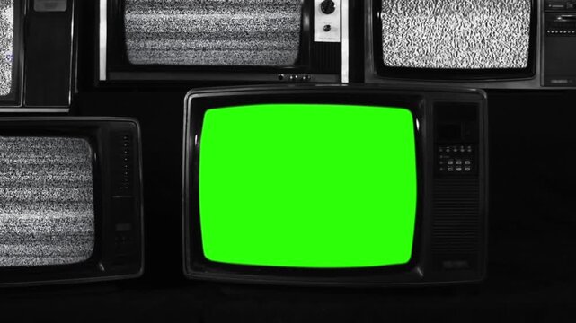 Vintage Television Turning On with Green Screen Surrounded by Static Retro TVs - Black and White Tone