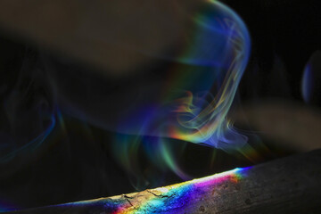 Ethereal abstract background with magical wisp of colorful smoke. This iridescent vapor with...