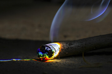Mesmerizing close up of burning rainbow ember with colorful fire and abstract smoke. vibrant,...