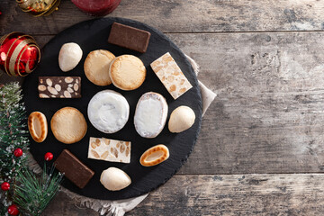 Traditional Spanish Christmas sweets assortment on wooden table. Top view. Copy Copy space