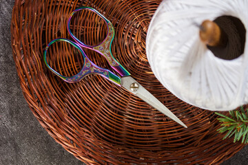 Top view of crochet tools and yarn in a basket on rustic wooden table. Cozy handmade workspace...