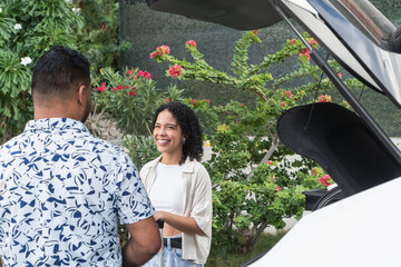 Couple preparing car for travel trip outdoors