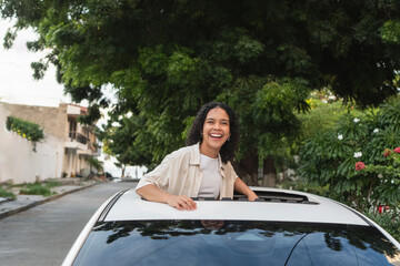 Woman enjoying car sunroof ride feeling freedom