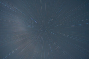 Cosmic light streaks against a dark night sky