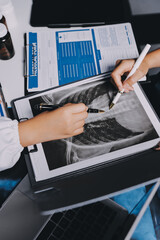 Group of doctors attending seminar in hospital lecture hall with senior physician giving medical...