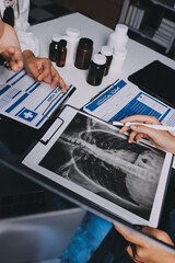 Group of doctors attending seminar in hospital lecture hall with senior physician giving medical...