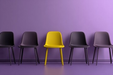 A bright yellow chair is positioned in the center of a line of dark chairs against a purple wall. The room features modern design elements and a sleek floor
