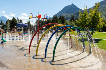 Vibrant splash pad featuring colorful arches and playful water features. © Viks