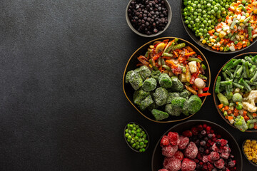 A variety of frozen vegetables and fruits arranged in plates, set against a dark background, capturing the essence of summer preservation for winter meals