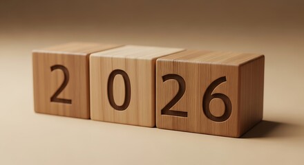 Three wooden blocks with the year 2026 carved into them, set against a neutral background.