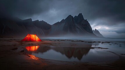 Orange Tent By Dramatic Coastal Mountains At Dusk