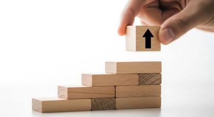 Hand placing wooden block with upward arrow on stair like structure