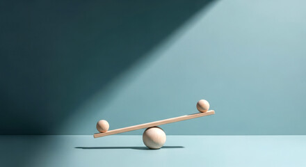 Simple seesaw balanced on a stone with dramatic light and shadow