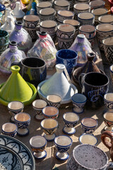 Colorful Moroccan ceramic tagines and cups on display, showcasing traditional craftsmanship, vibrant glazes, and intricate patterns. Authentic North African pottery for cultural and culinary themes.
