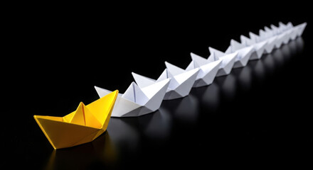 Single yellow origami boat leads a line of white paper boats