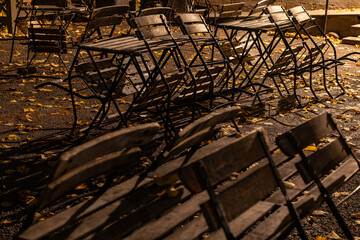 Stockholm, Sweden Outdoor tables and chairs in a park on autumn night.