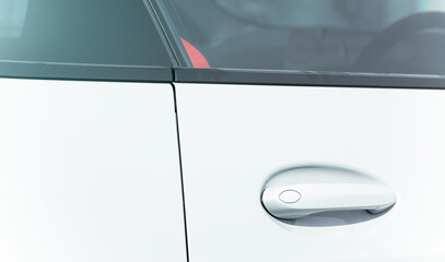 Obraz premium car handle door lock closed frame white metallic smooth background with glass close up vehicle view in salon for retail activity