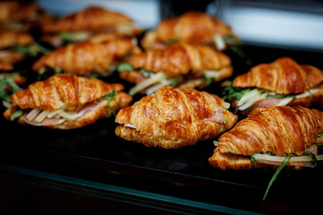 Croissant sandwiches with ham cheese and arugula