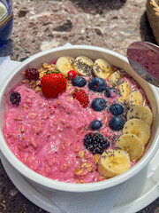 Berry smoothie bowl with blueberry, strawberry and banana and chia seeds and granola