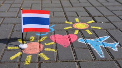 The Thai flag and children's chalk drawings on the asphalt. Concept: Children's Day