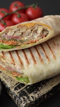 Shawarma with chicken or beef, tortilla roll, and vegetables. Shawarma with meat