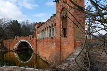 The Red (or Knight's) two-arched pseudo-Gothic bridge spans the channel between two large ponds in...