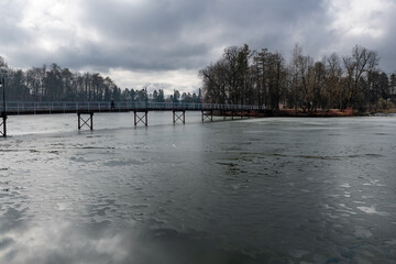 Fototapeta premium Long bridge to the island on the pond